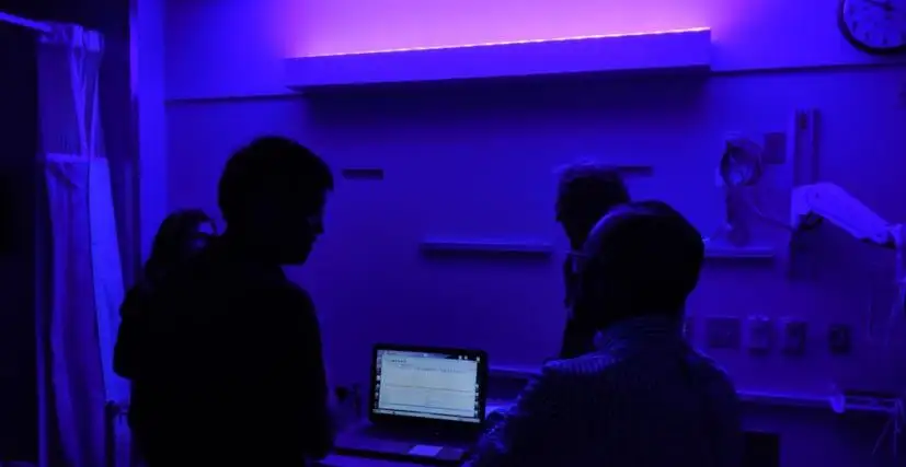 Hospital room cast in purple light