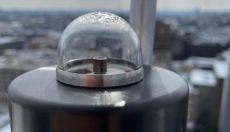 Rooftop spectrometer appears as a smooth grey disc base with a small glass dome to capture sunlight