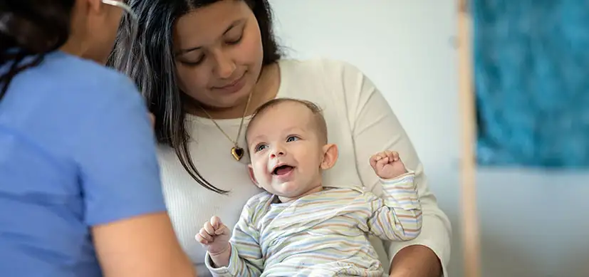 Mother and infant talking with a home care worker