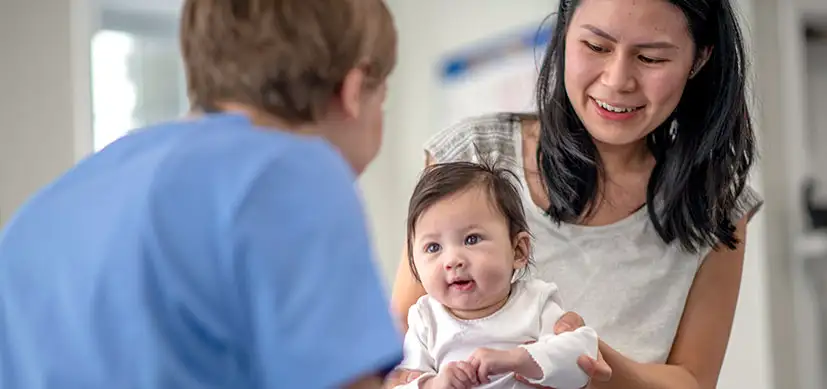 Photo of home visiting nurse with mother and baby