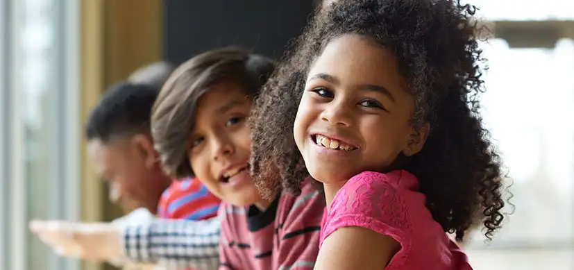 Photo of children smiling at the camera