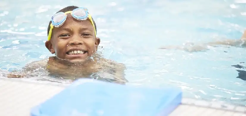 Smiling boy swimming