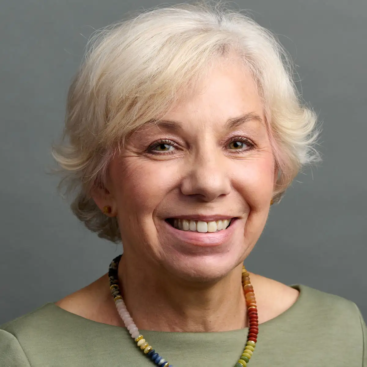 Hermine Brunner wearing a green shirt and necklace