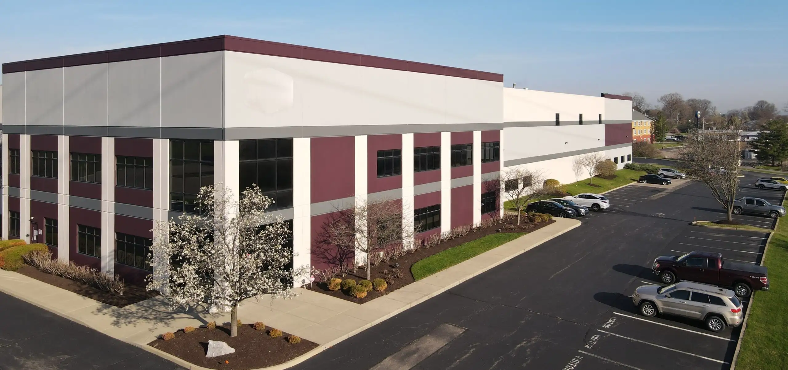 Modern, single-story white building with large dark windows in Sharonville, Ohio, to be home to Cincinnati Children's new Applied Gene and Cell Therapy Center.