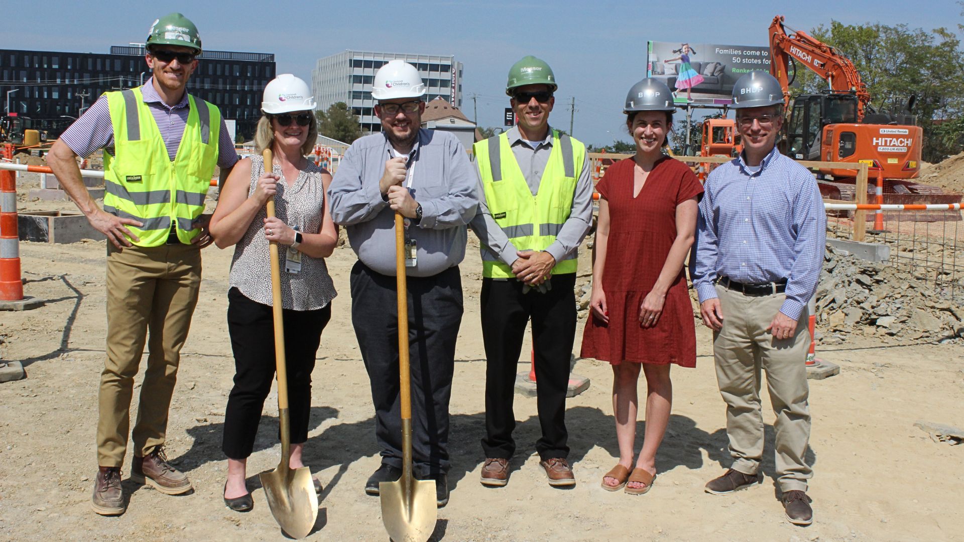 Photo of Michelle Adams, PhD, MHI, vice president of Research Operations and Shared Facilities, and Jason Luthy, director of Space Planning, with members of Messer Construction Co. and architects from design firm BHDP.