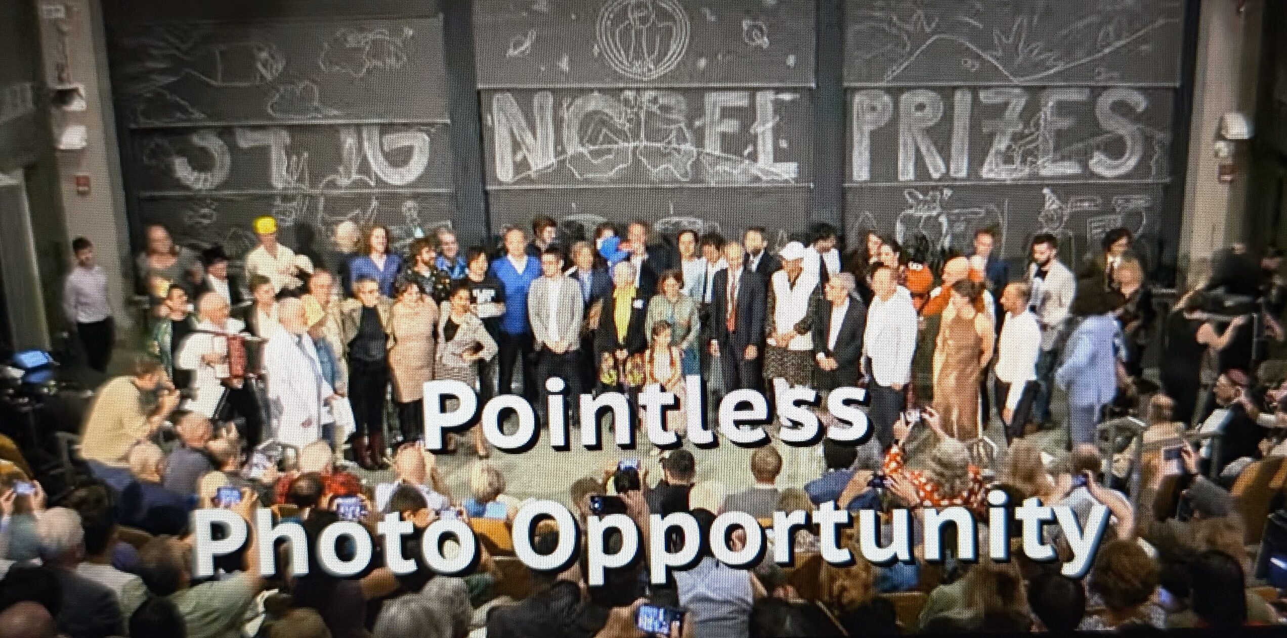 Winners and presenters gather on stage for a 