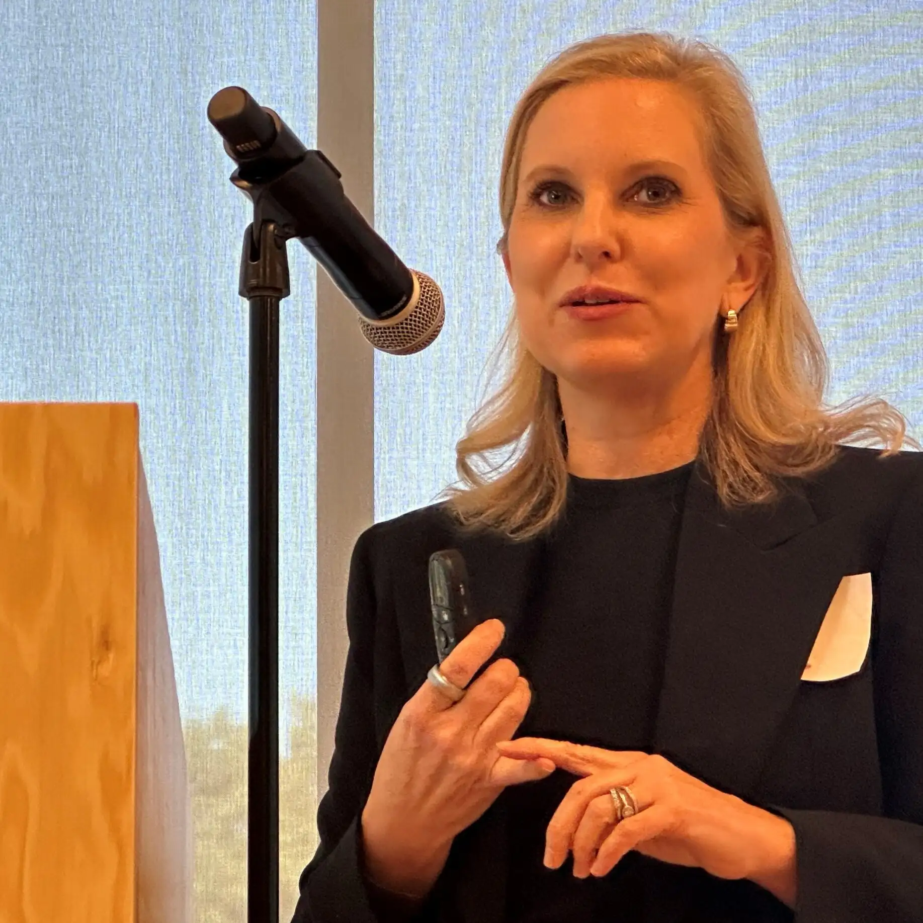 Photo of Angela Lorts, MD, MBA, speaking a microphone