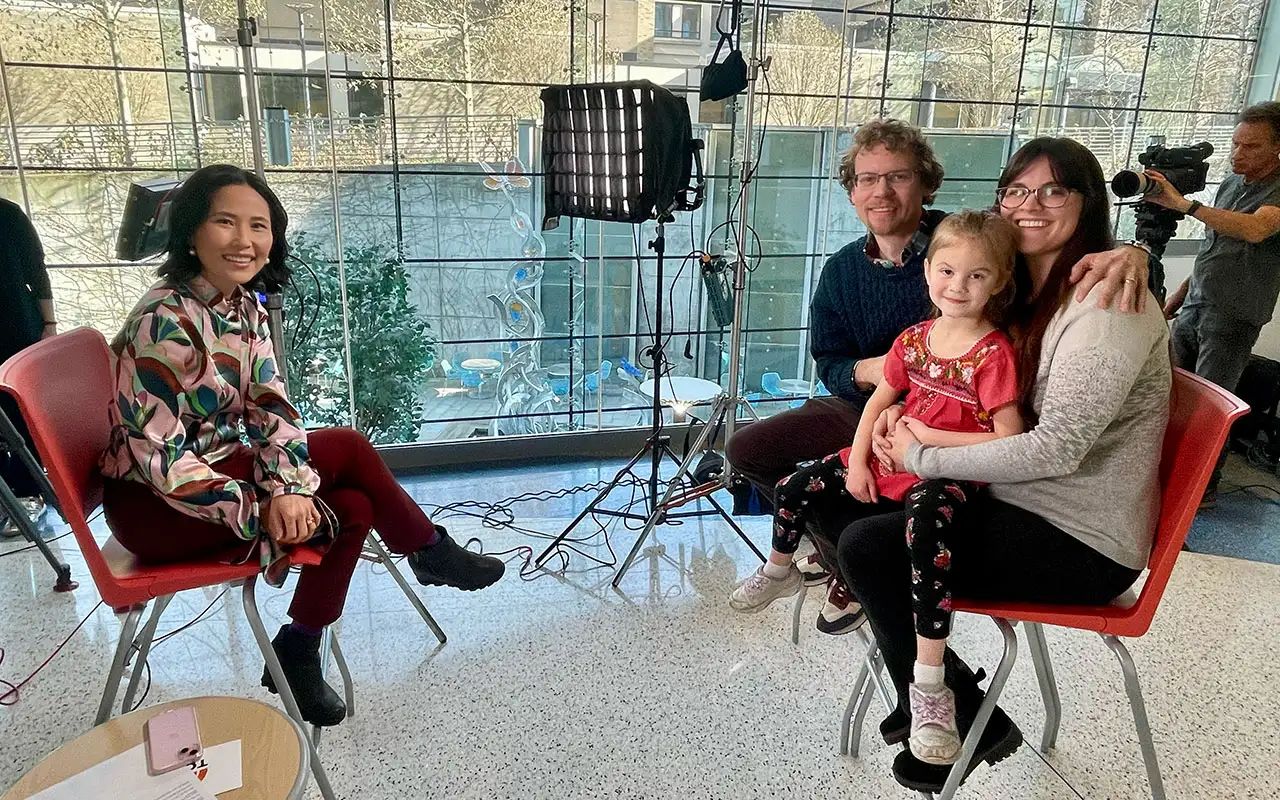 A family involved in the study and a Today Show news reporter smile for the camera